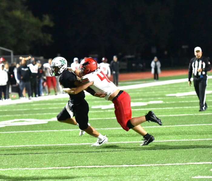 Westmoore linebacker Connor Cavnar (right) makes a tackle on a Norman North ballcarrier during a recent game.